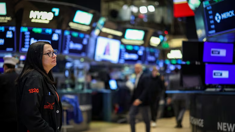 Traders work on the floor at the New York Stock Exchange